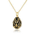Macro shot of Fabergé-style egg pendant with black enamel and gold vine patterns - Black