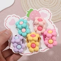 Detail showing five pairs of colorful flower hair elastics on a cute strawberry card - Multicolor Mixed