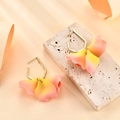 Chic pearlescent rose red flower petal earrings on a stone with warm studio lighting - Pink Yellow Gradient (A424)