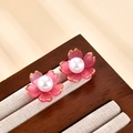 French style floral earrings with pink petals, gold edges, and a central pearl on a wood stand - Pink Flower Style (A441)