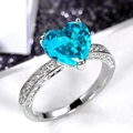 Macro shot of silver ring with heart-cut blue gemstone and micro-pave white zircons - Light Blue