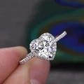 Fashionable heart-shaped zircon halo ring with pavé diamond band worn on finger - US 5 / White Gold