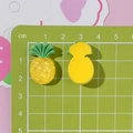 Vista macro di ciondoli ananas in resina gialla da 2cm per fai-da-te con scala - Ananas