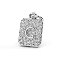 Macro detail of silver rectangular pendant featuring cubic zirconia inlaid letter G - Letter G