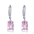 Macro detail of rectangle pink gemstone earrings with silver leverback closure on white - Pink