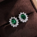 Macro detail of sunflower stud earrings with oval green gemstone and zircon halo - Green