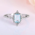 Elegant silver crown ring with rectangular light blue gemstone and white zircon accents - US 5 / White Gold