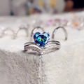 Macro shot of V-shaped ring featuring heart-shaped rainbow gemstone and micro-pave diamonds - Colorful / US 5
