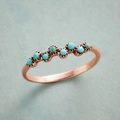 Detail of rose gold ring featuring seven turquoise stones in a wave arrangement - Size 6 / Rose Gold