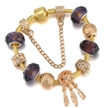 Bracciale a catena serpente dorata con perle di cristallo viola e ciondolo piuma - Acchiappasogni in Cristallo Viola (014)