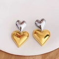 Macro shot of two-tone heart stud earrings in polished gold and silver metal finish - Two-tone Gold (Large)