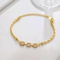 Detail of gold bamboo chain bracelet with three square cubic zirconia accents - Bamboo Link Square White Gem Gold