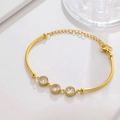 Close-up of a gold bracelet with three round cubic zirconia stones and a lobster clasp - Round White Gem Gold