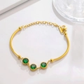 Detail of gold bamboo chain bracelet with green crystals and round bead edging accents - Round Green Gem Gold
