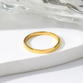 Minimalist gold-plated stainless steel ring shown on white display stand with water ripple background - US 5 / Gold