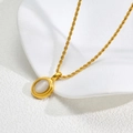 Elegant gold tassel necklace featuring a twisted chain and white moonstone pendant - Gold - White Cat's Eye Oval C56