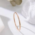 Three-diamond minimalist 18k rose gold titanium steel ring for women shown on white stone - US 4 / Rose Gold