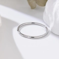 Macro detail of silver minimalist ring with three small inlaid crystals on a white stone - US 4 / Silver