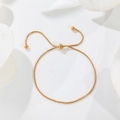 Detailed close-up of golden adjustable snake chain bracelet with polished slider bead - B138 Adjustable Bracelet / Rose Gold