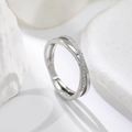 Detailed view of silver criss-cross ring with pavé diamond accents on stone - US 5 / Silver