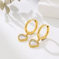 Macro detail of gold hoop earrings with mother of pearl heart pendants and crystal trim - White-Gold