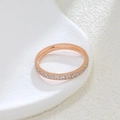 Macro shot of rose gold half-eternity ring with sparkling round-cut cubic zirconia - US 5 / Rose Gold