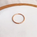 Minimalist rose gold ring with a single small crystal on a clean white tray display - US 5 / Rose Gold