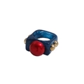 Detail of blue marble resin ring featuring a red sphere and golden metal accents - Sapphire Blue