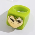 Close-up of green resin ring featuring a large gold heart accent in Y2K aesthetic style - Green
