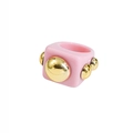 Close-up of pink Y2K resin ring with golden bubble studs and metallic accents - Pink
