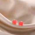 Detail of round gold-rimmed stud earrings with red enamel on champagne silk fabric - Red Round