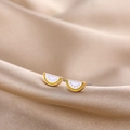 Macro shot of cute watermelon enamel stud earrings with gold finish on silk - Clear Quartz