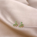 Detail of gold snake earrings with green enamel on elegant champagne silk background - Green Snake