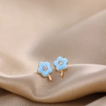 Close-up of a blue enamel five-petal flower stud earring with a central clear zircon - Blue Flower Style