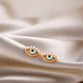 Detail of evil eye stud earring with orange enamel and gold base on silk background - Orange Evil Eye