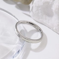 Minimalist silver titanium ring with white enamel and centered diamond on stone surface - US 5 / White Enamel Steel Tone