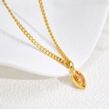 Macro detail of gold rope chain necklace with marquise-cut amber stone pendant - Gold - Yellow Zirconia B350