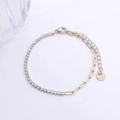 Detail van 18K vergulde roestvrijstalen armband met zirkoon tennisketting en paperclip-schakels - Goud / Witte Strass