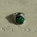 Detail view of oval green malachite stone on polished silver-tone stainless steel ring - US 6 / Silver with Malachite
