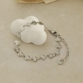 Silver stainless steel heart bracelet with radial texture and lobster clasp on white decor - Bracelet / Silver
