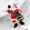Classic Santa Claus brooch with red enamel and green gift bag on a festive background - Santa Claus Style