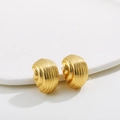 Detailed close-up of 18K gold-plated stainless steel croissant hoop earrings on white stone - Shell Textured Bean