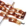 Detail view of amber acrylic eyewear chain with rectangular links and silicone loops - Brown Square (GC063_2)