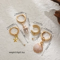 Guida alle dimensioni per set di orecchini dorati con conchiglie e stelle marine - Bianco