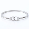 Silver stainless steel handcuff bangle with sparkling cubic zirconia on white background - Steel