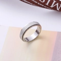 Macro detail of rotating stainless steel ring with sandblasted finish and polished inner band - Number 5 / Steel