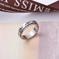 Brushed stainless steel spinner ring with engraved black moon and star patterns - US 5 / 6mm Width