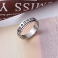 Polished stainless steel spinner ring featuring engraved daisy patterns for anxiety relief - US 5 / Daisy Flower Style
