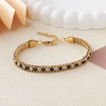 Double-row golden stainless steel bracelet with black and clear cubic zirconia accents - Gold + Black and White Rhinestone