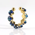 Macro detail of 18K gold C-shaped ear cuff with square-cut dark blue gemstones - 511 Blue Zirconia